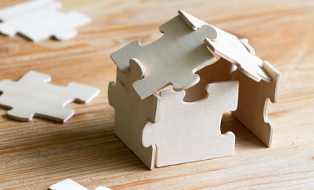 Image of puzzle pieces making a house