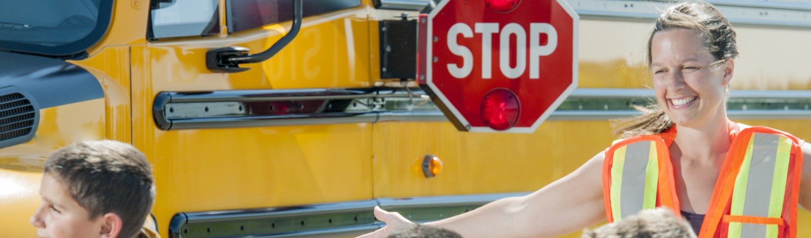 School bus with Stop sign arm out with the words Stop on the sign
