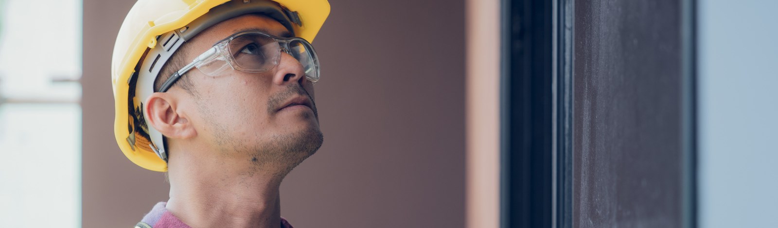 Construction Inspector with safety glasses and yellow hard hat