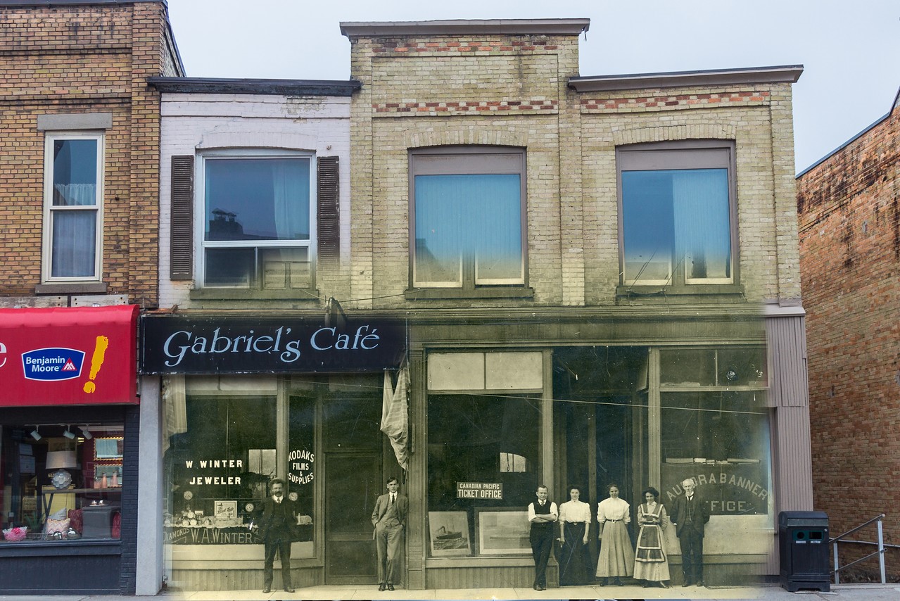 A partially colourized and partially black and white photo of a store façade. The image blends an archival photo from 1910 with an image taken in 2018.