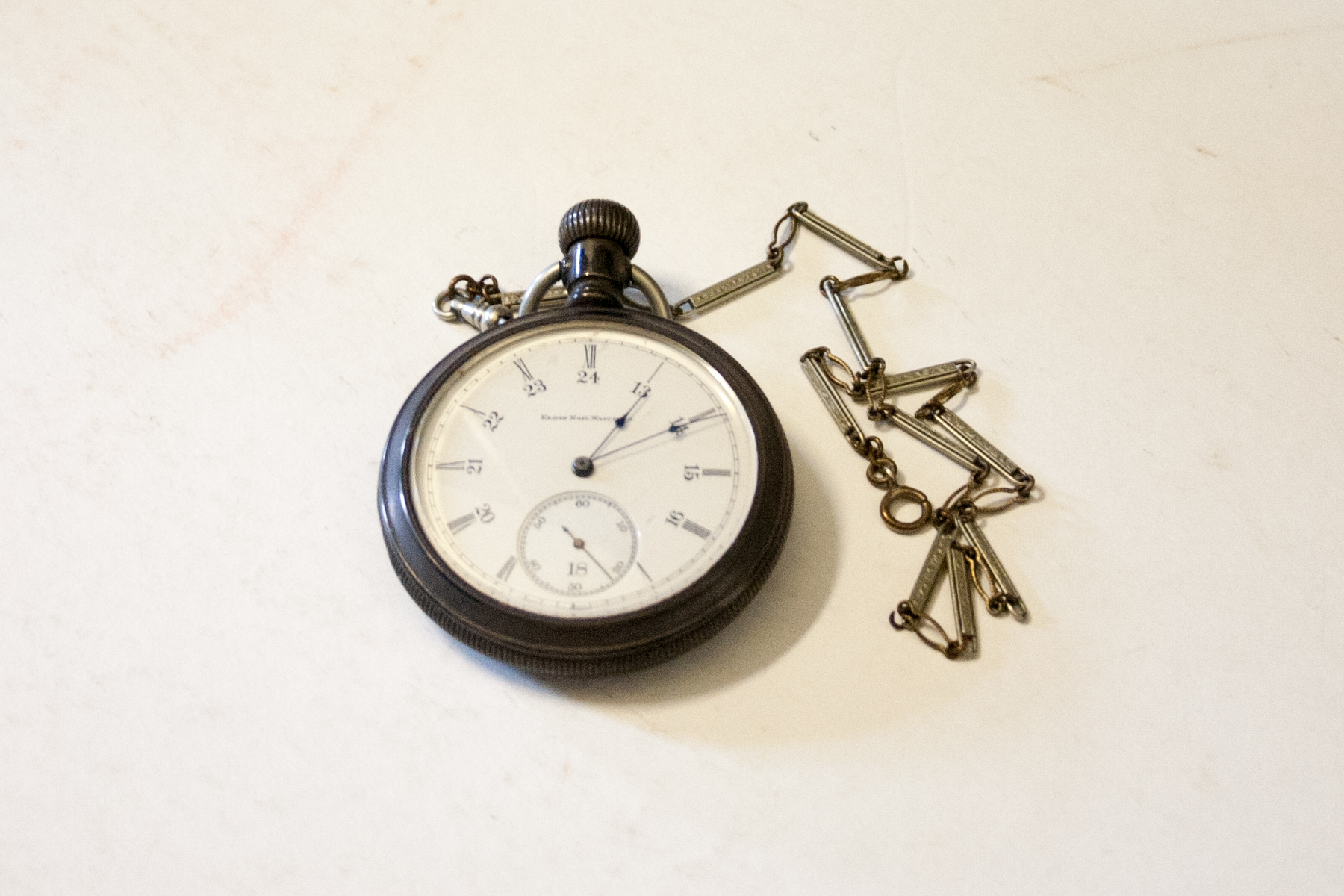 A colour photo of an antique pocket watch from the 1920s. 