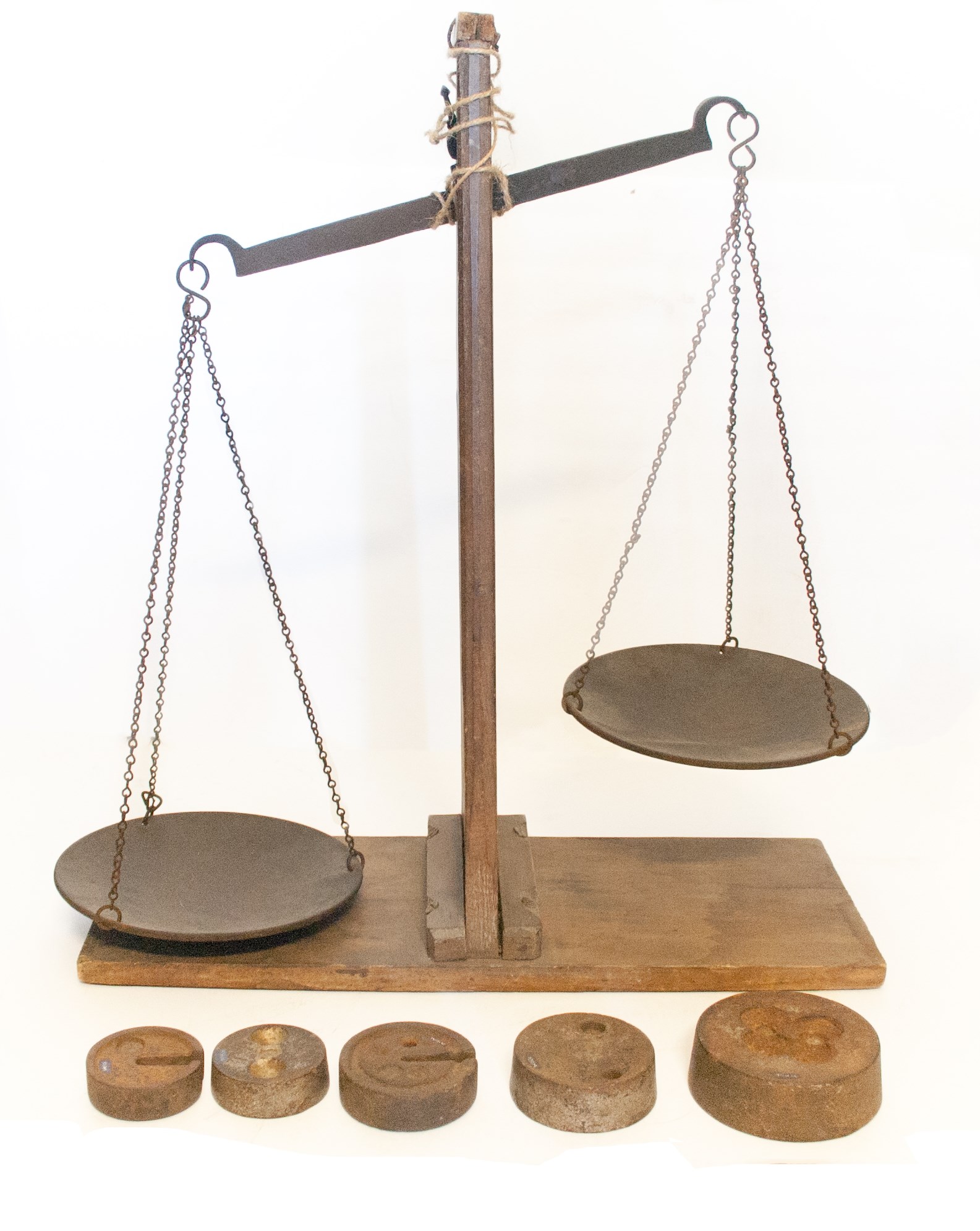 A colour photograph of a brass and wood scale and weight set from the early 1800s.