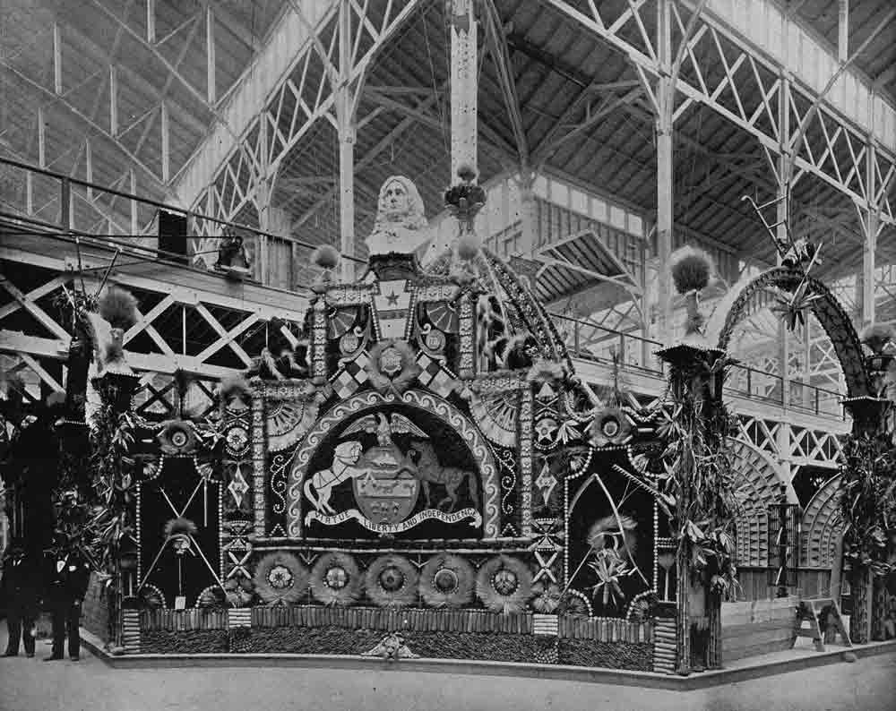 Black and white photo display background featuring crest and motto