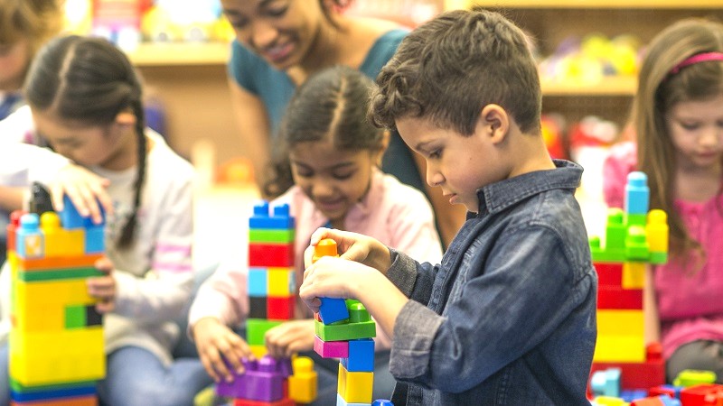 Group of preschool kids playing with block