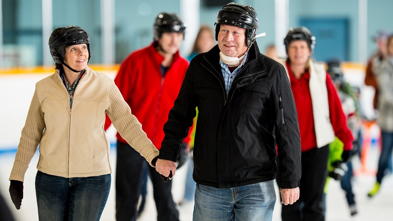 Senior couple ice skating indoor ice rink