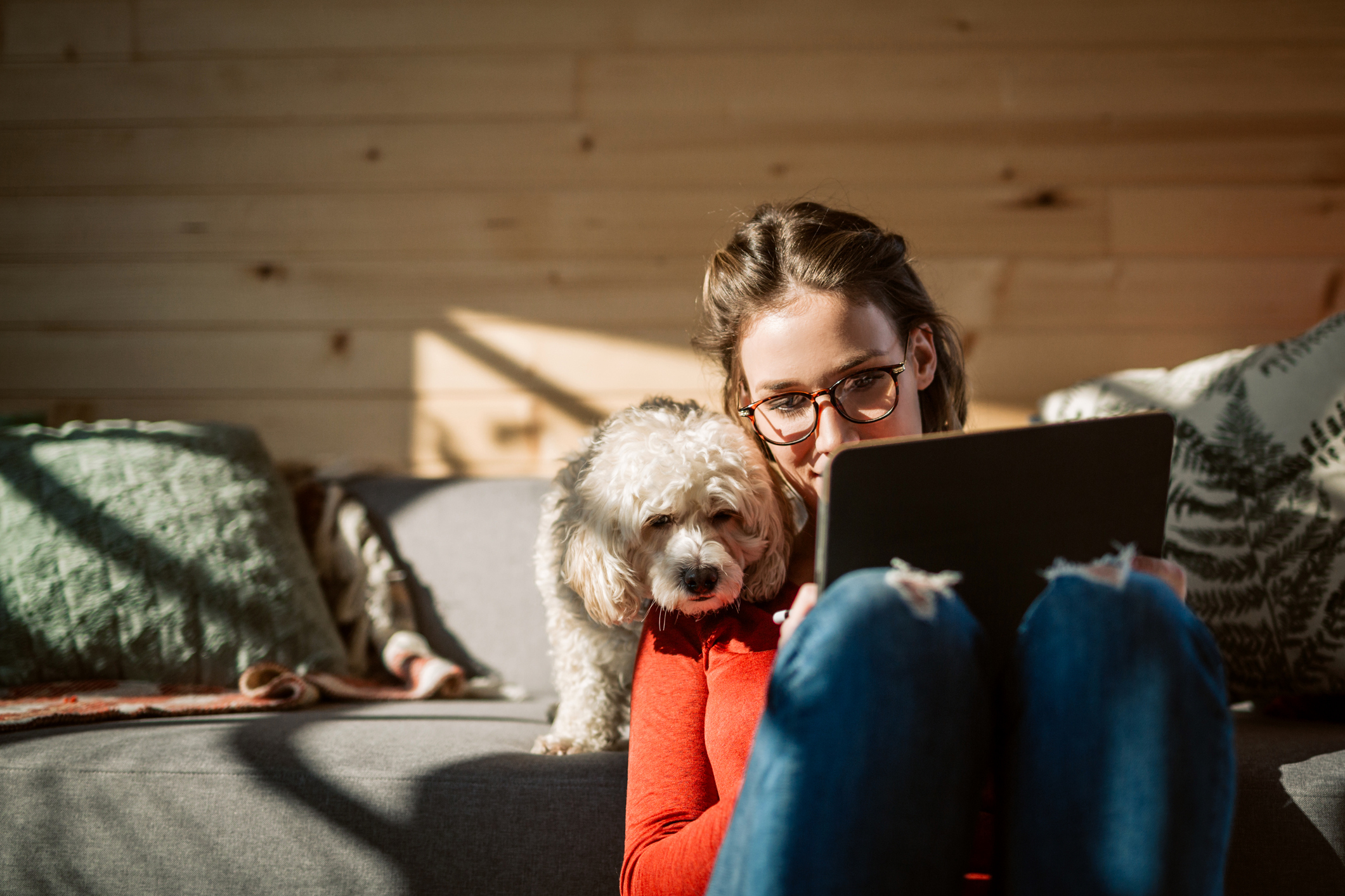 woman cuddling with dog