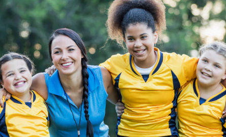 Girls soccer team with female coach