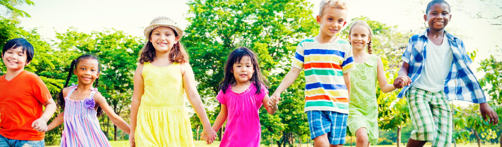 Kids holding hands and running in the summer