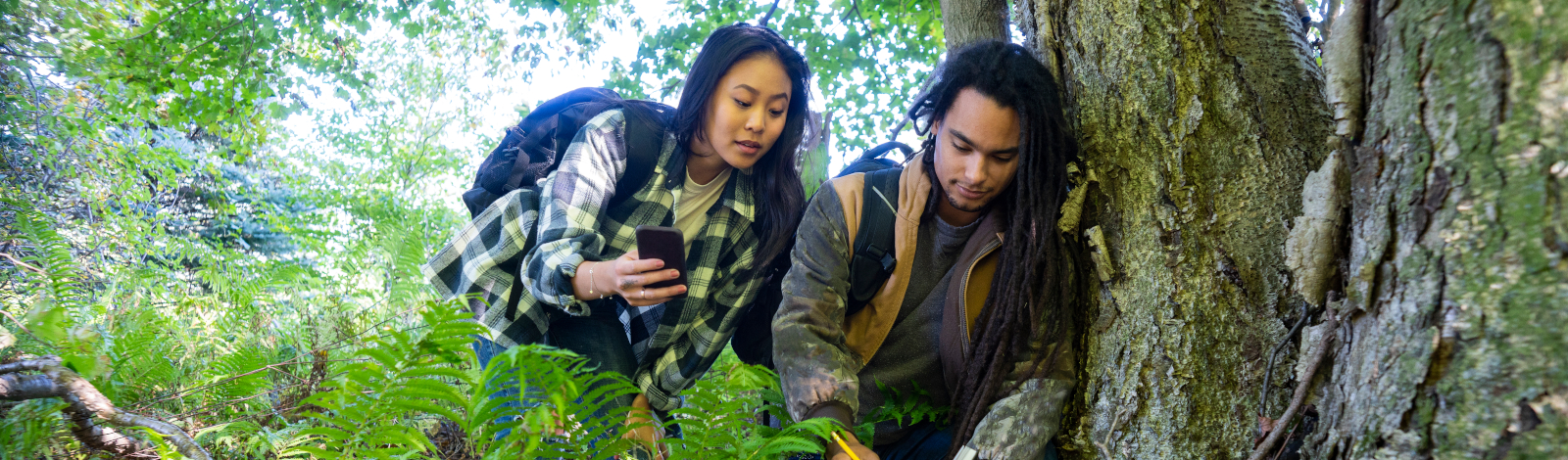 Young couple geocaching in the forest