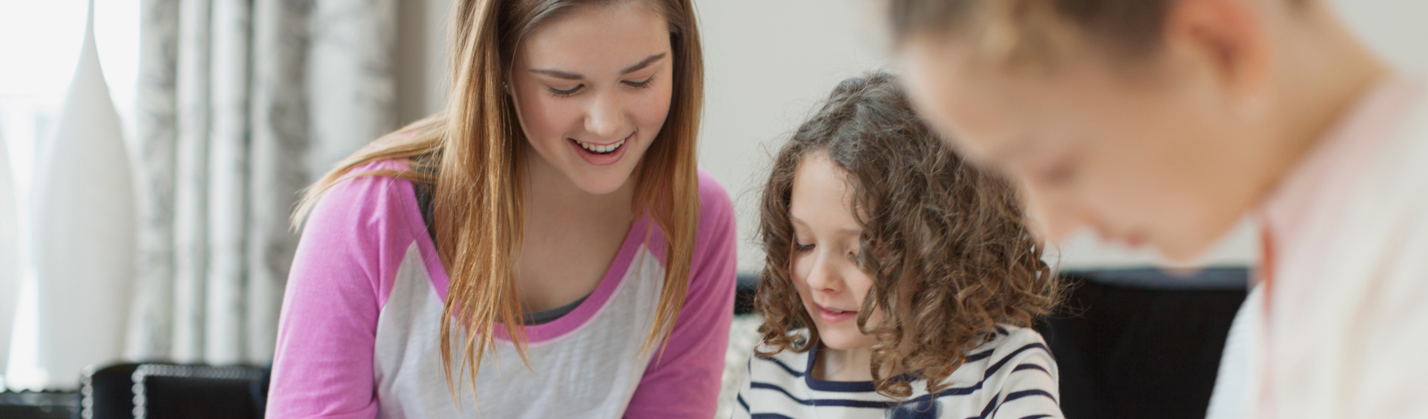 Teen assisting younger student with assignment