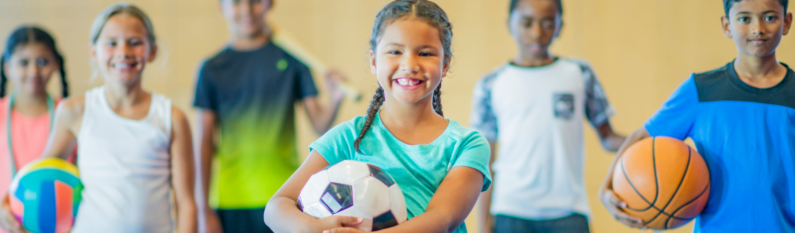 Groups of kids with various sports balls