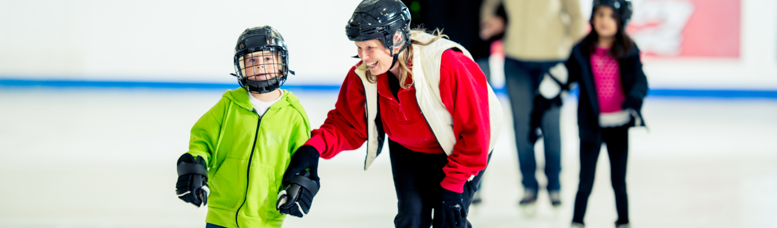 Boy and mom ice skating