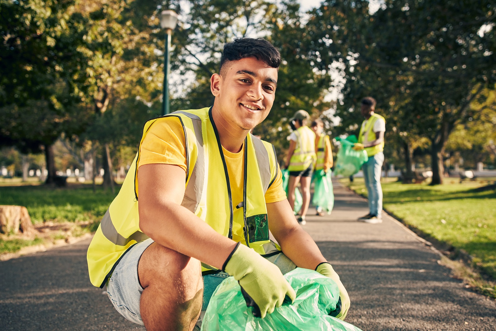 Teen boy volunteering at park cleanup