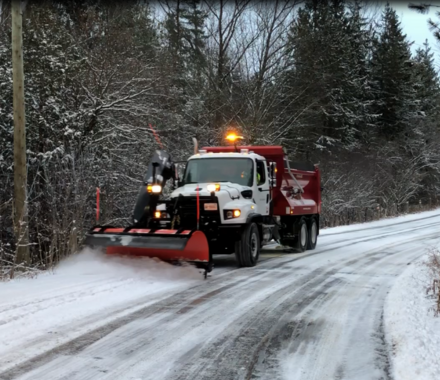 Snow Plow plowing the road