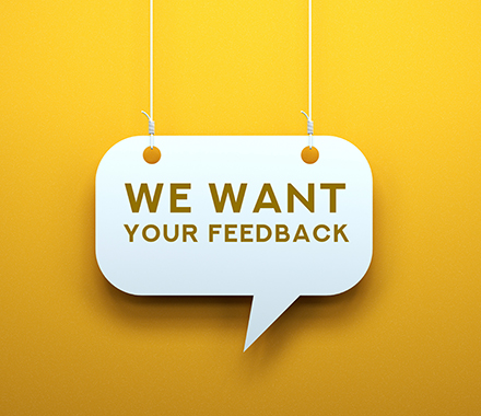 Speech bubble on a yellow back, with words "We want your feedback"