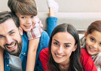 Family huddled together and smiling