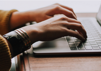 Hands typing on a keyboard