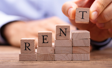 Scrabble pieces that spell out Rent