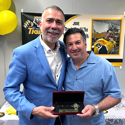 Joe Bentolila standing with Mayor Mrakas, holding up the key