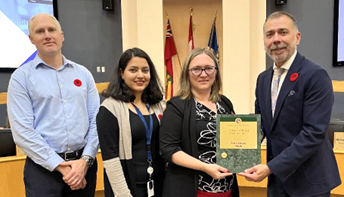 Mayor Tom Mrakas presenting Town of Aurora’s Finance Team with the Certificate of Recognition