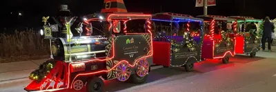 Train decorated in Christmas themed decorations and lights