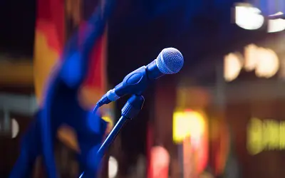 Microphone in front of a dark and colourful background