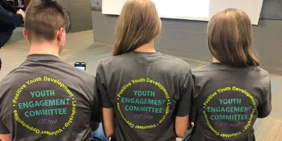 Three teens wearing YEC t-shirts