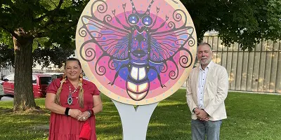 Mayor and participants displaying Indigenous art at park