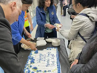 Happy New Year cake being cut and handed out to event attendees