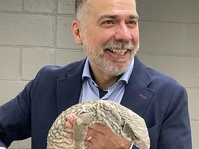 Mayor Tom Mrakas holding a lizard
