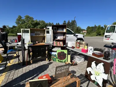 Image of a table at a garage sale with household items for sale