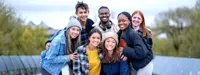 Group of teens huddled outdoors fall season