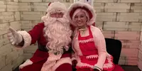 Santa and Mrs Claus at Christmas event sitting on chair