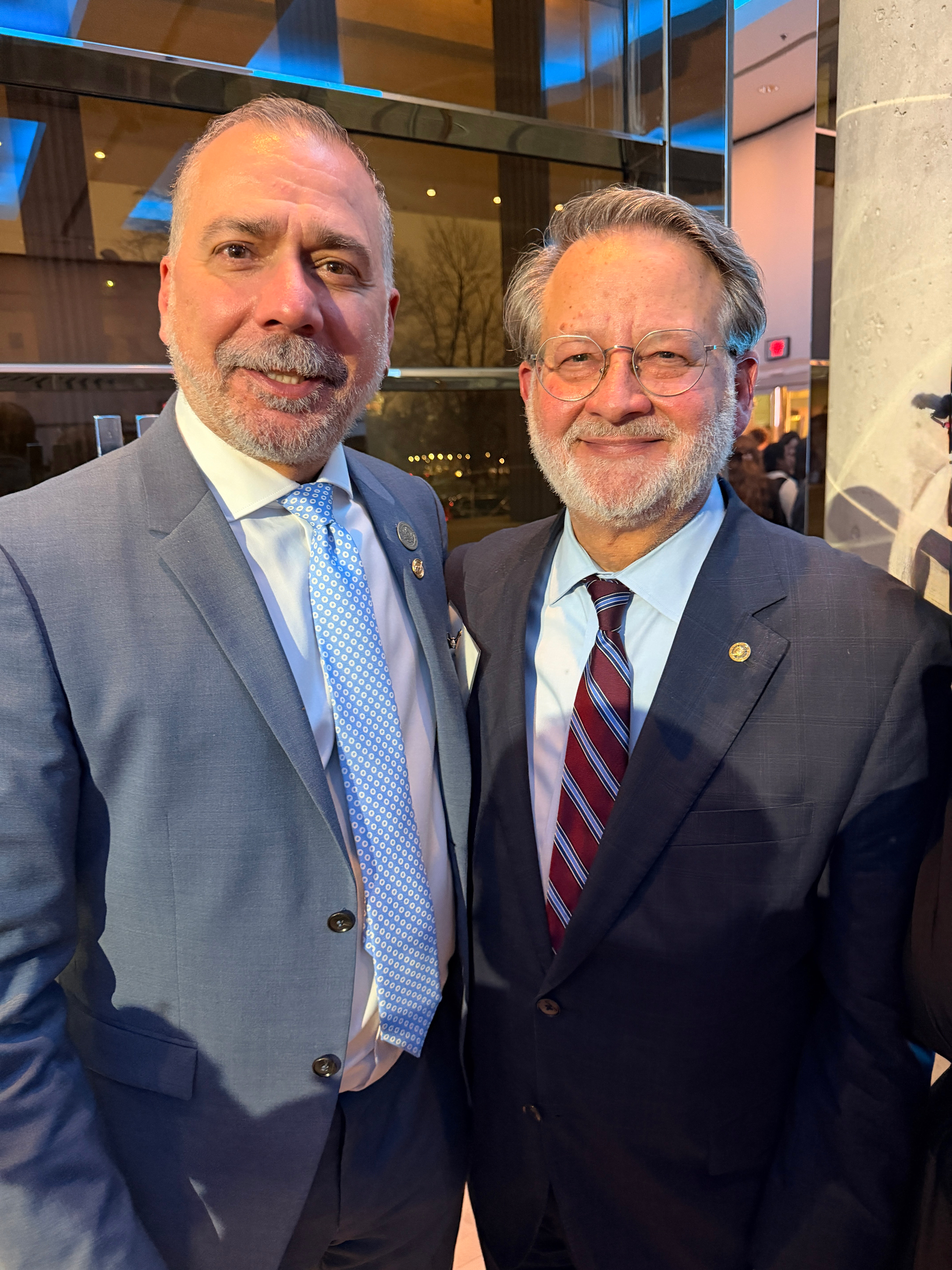Mayor standing beside a gentleman inside a building