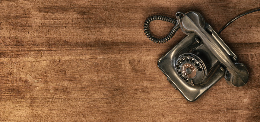 Moody picture of a very old phone on a wood surface