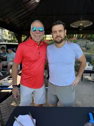 Two man, side by side posing for a picture