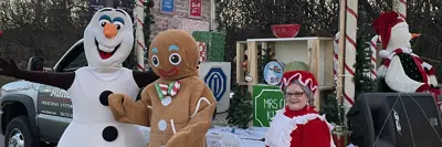 People dressed as Olaf, Gigerbread Man and Mrs Claus at Santa parade event