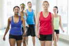 Five adults walking on indoor track