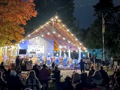 Bandstage at night with band and people watching