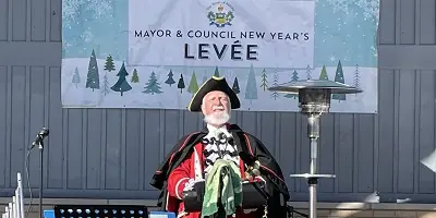 Town Crier in front of stage at park outdoor event