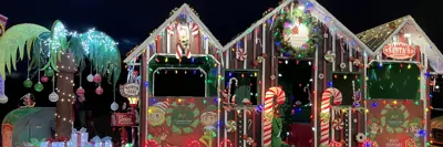 Christmas decorated palm tree and wooden huts