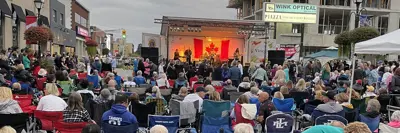 Saturday Night Fever night time stage band with large group of people in attendance